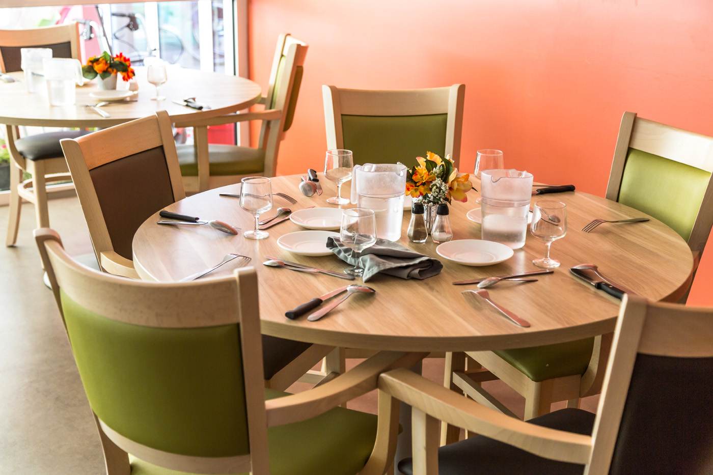 Round restaurant table set with plates and glasses